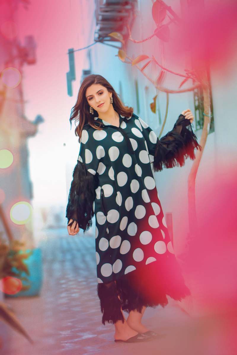 polka dot woman in black and white polka dot long sleeve dress person